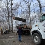The Mathias Precision team lowers a log onto a trailer during a tree removal in Lake St. Louis, MO.